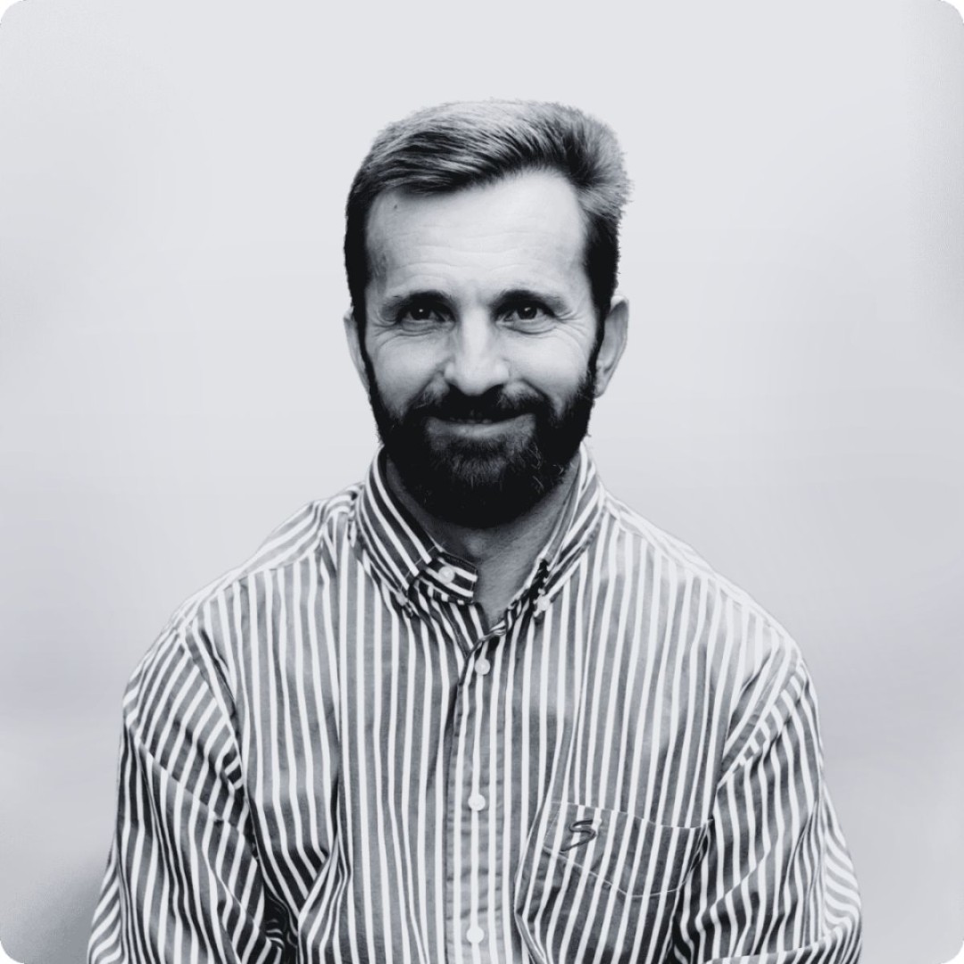 Man with beard in striped shirt