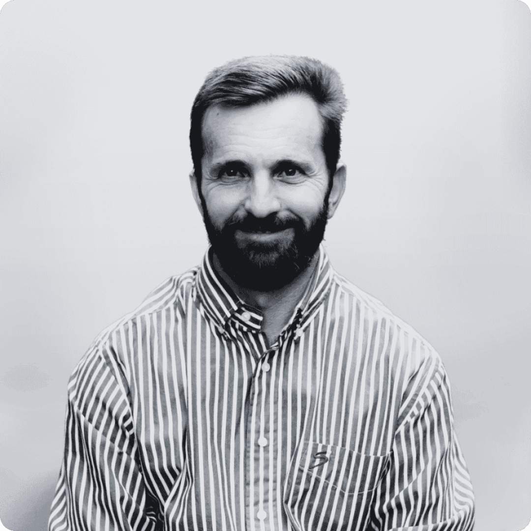 Man with beard in striped shirt.