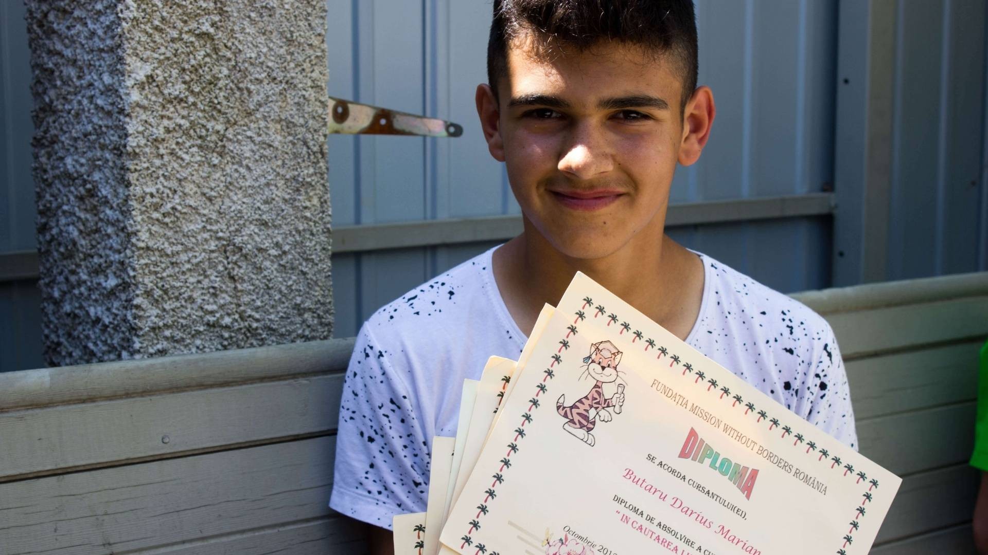 Teenage boy with certificates