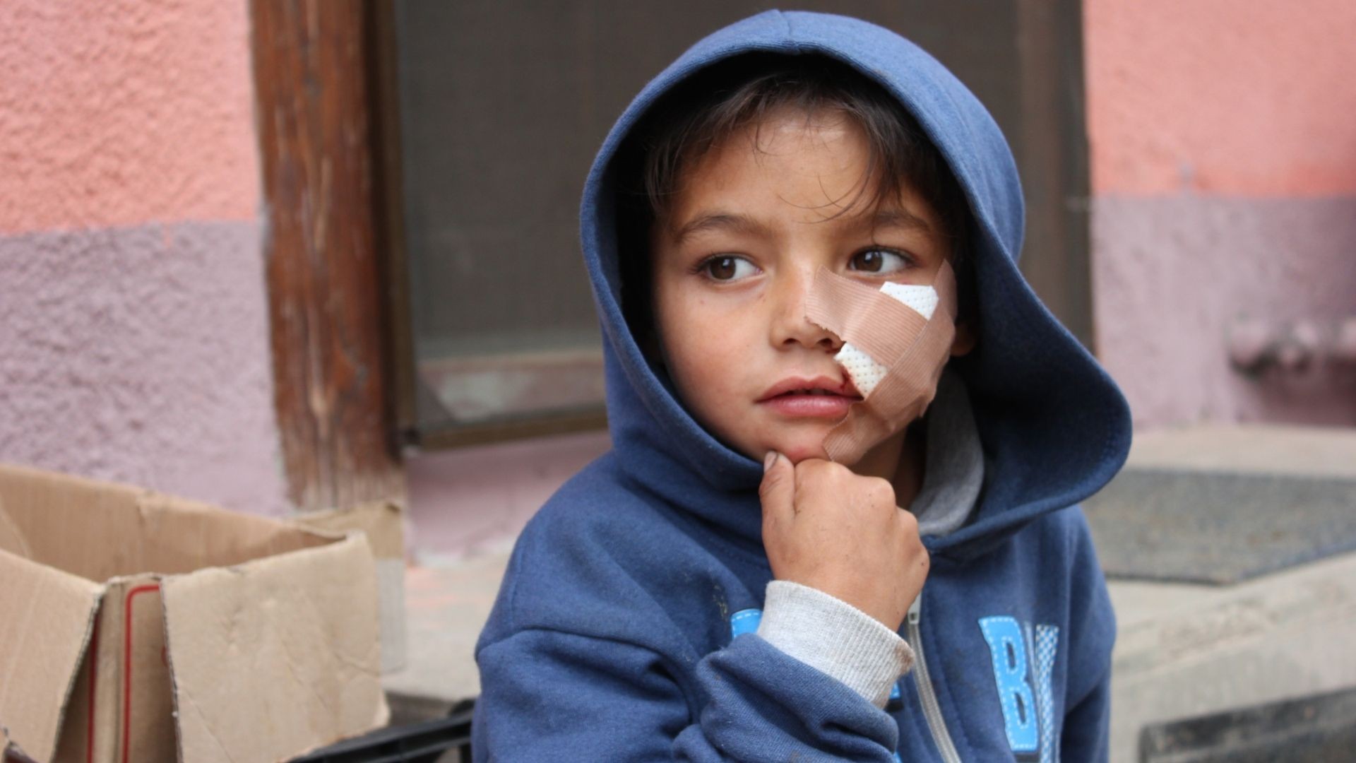 Injured boy with plaster on face