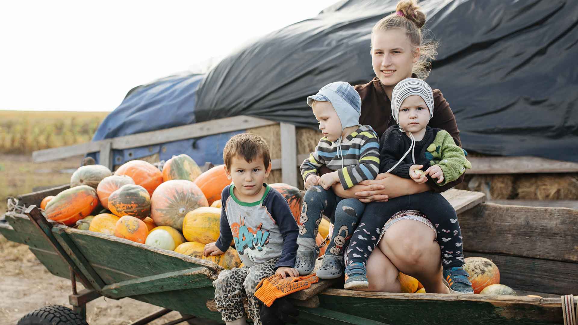 A family sat with their harvest of vegetables