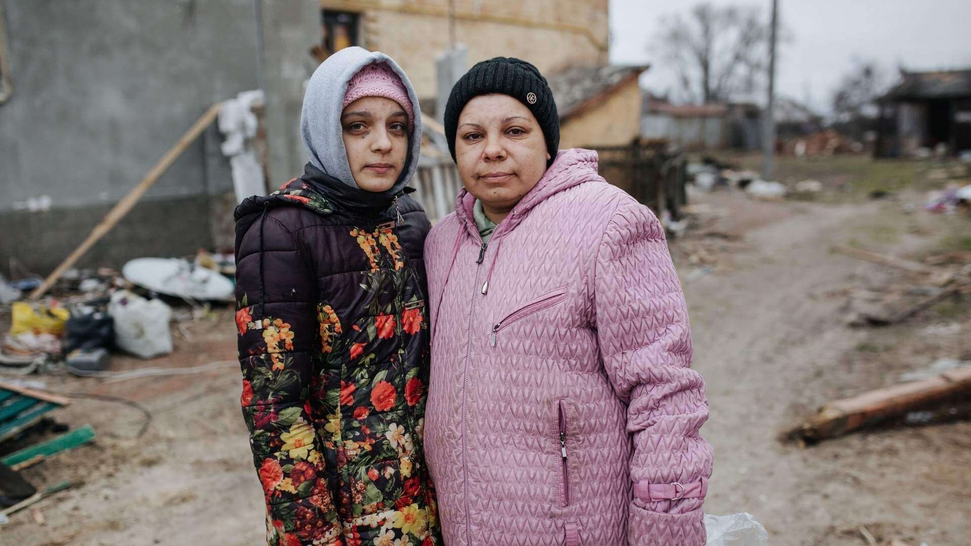 Young girl and older woman standing close to each other