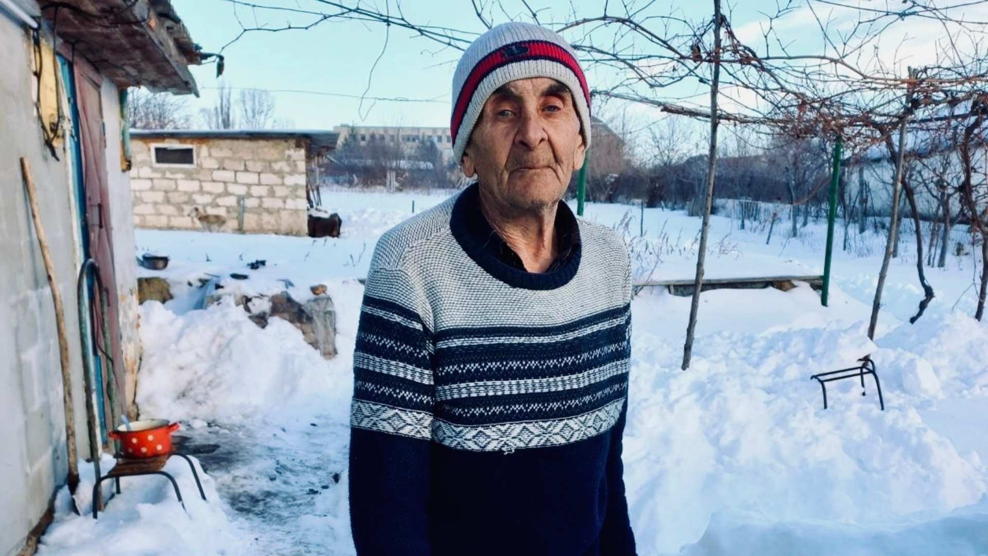 Elderly man outside in the snow