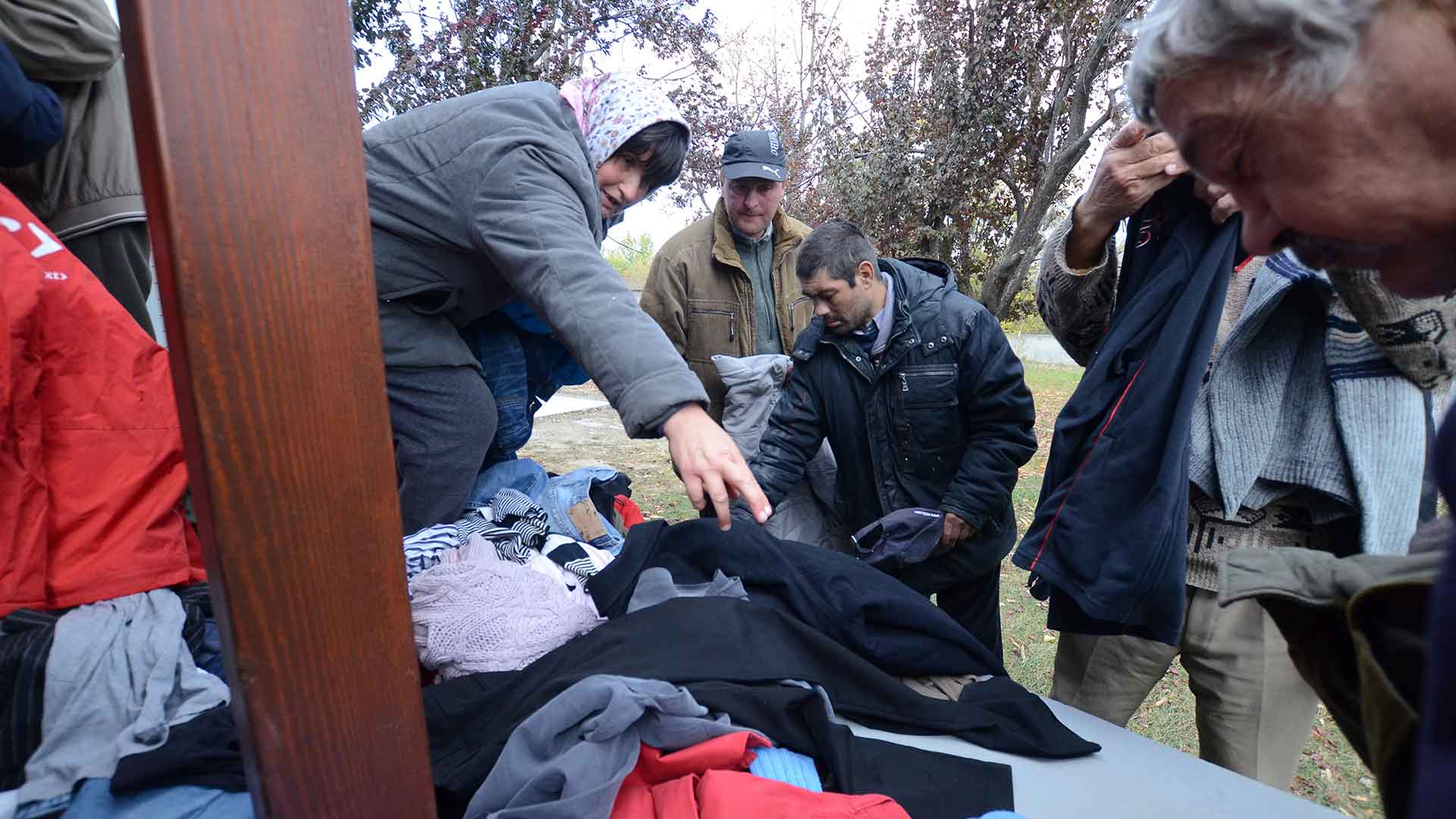 People receiving warm clothes.