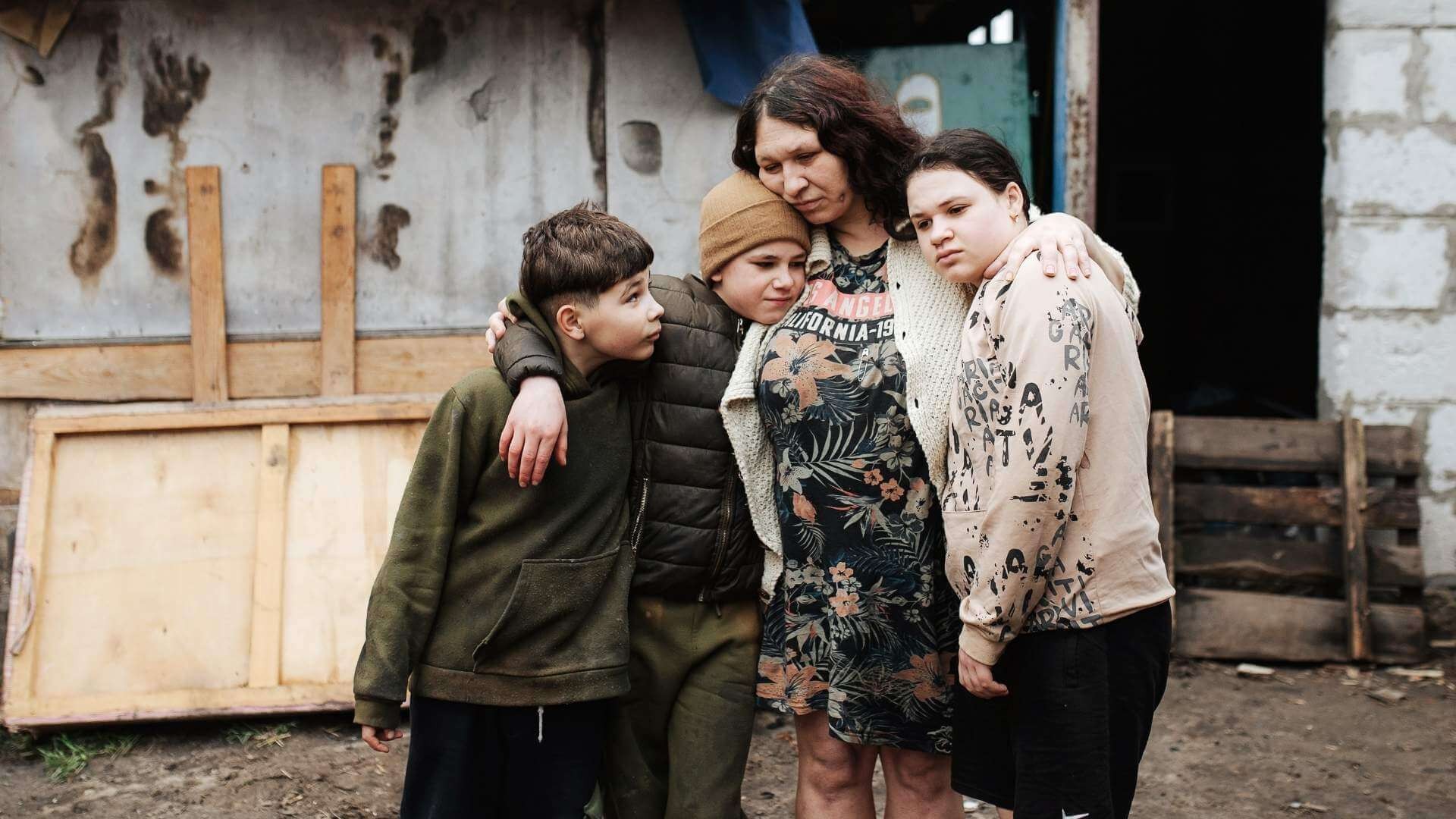 Woman and children in sad embrace