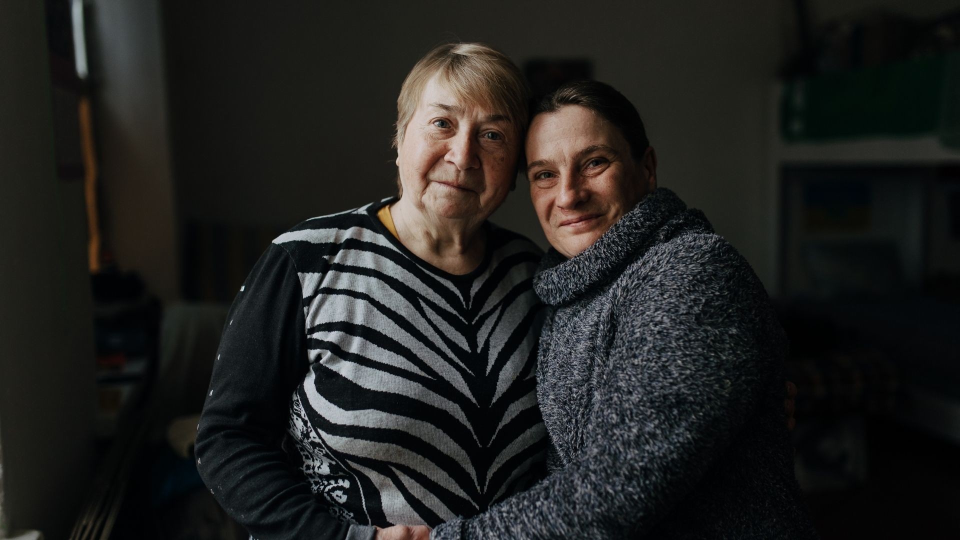 Two woman in comforting embrace